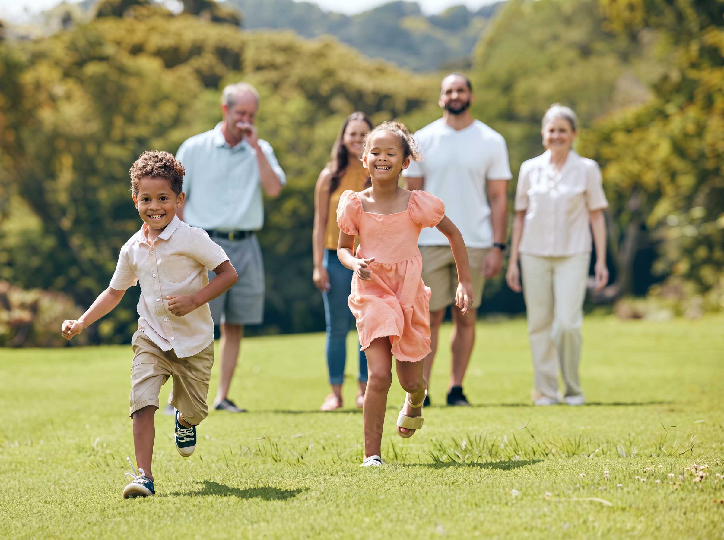 A family enjoying a sunny park, with a child running ahead